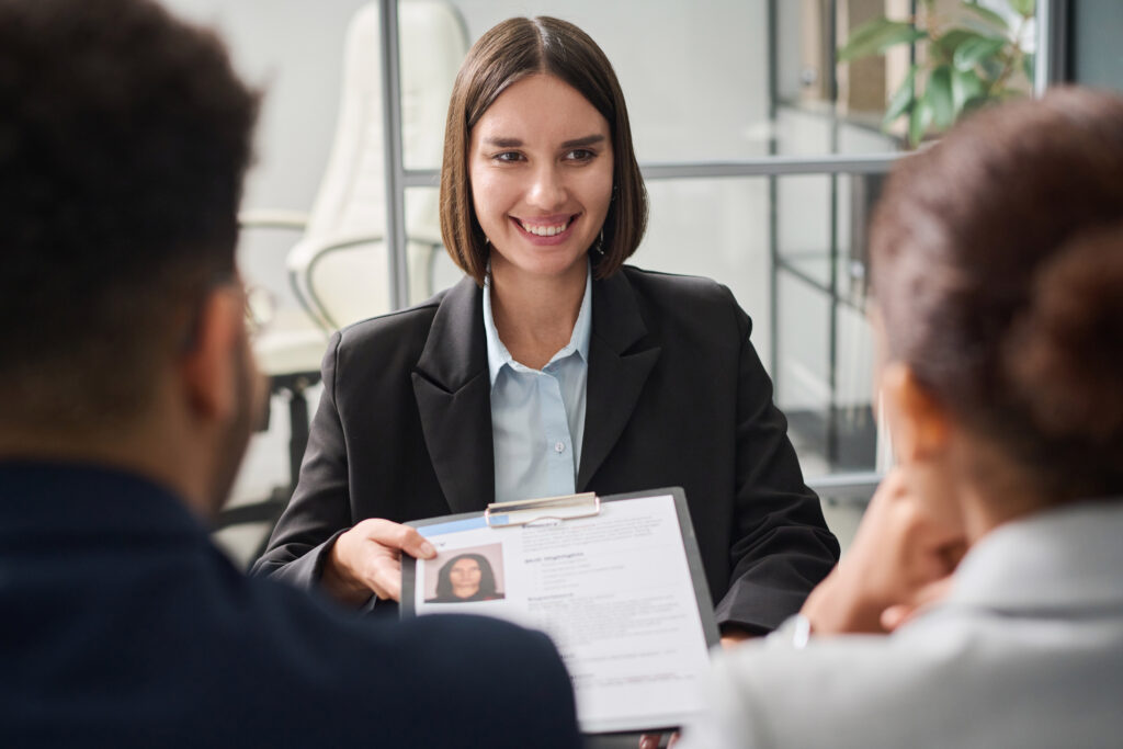 A job applicant submitting her resume during a hiring process.