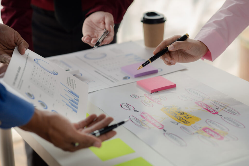 A group of individuals are gathered around a table discussing customer needs.